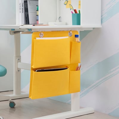 Yellow desk organizer with pockets, holding tablet, pencils, and bottle. BÖNSYRSA kids series.