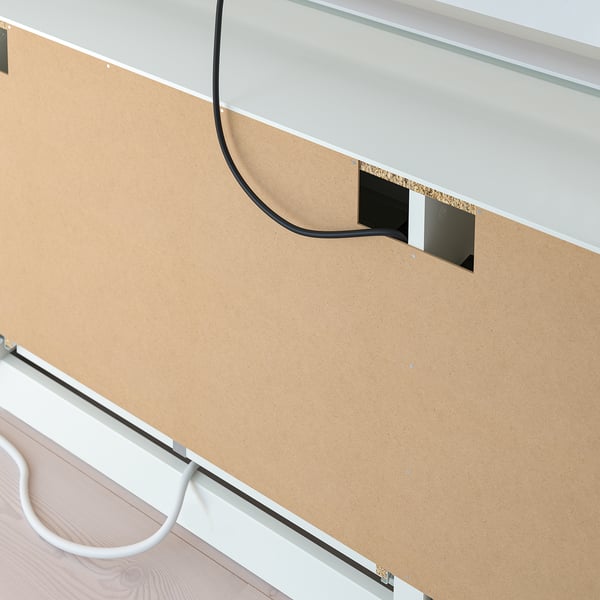 Close-up of a BRIMNES tv bench showing cable outlets and drawer for organised storage.