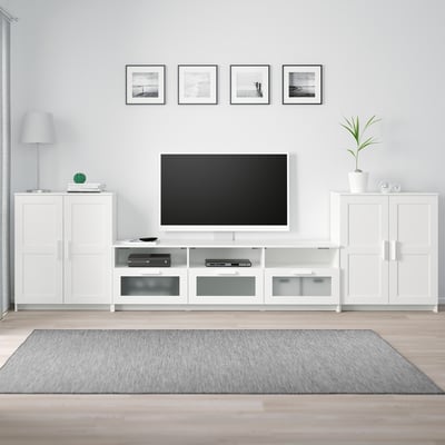 Modern living room with white BRIMNES tv stand, mounted tv, artwork, and decor.