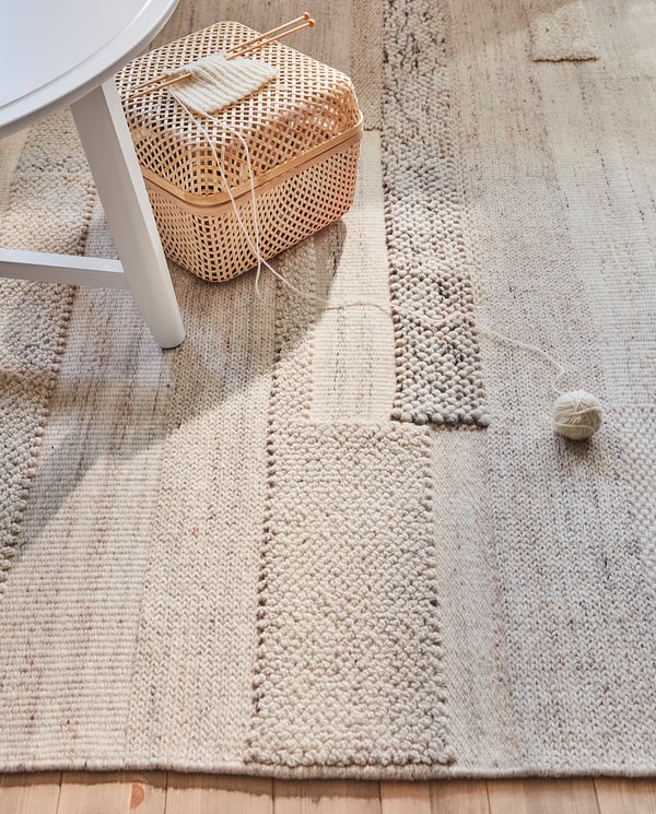 Handwoven BRÖNDEN rug, beige, natural fibers, rectangular, patterned texture.