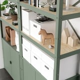 Shelf unit with wooden top, boxes, and decor. Supports heavy items, versatile for home use.