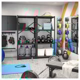 Home gym with BROR storage, dumbbells, kettlebells, mats, and geometric wall patterns.