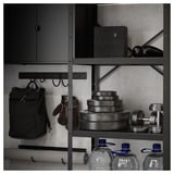 Black metal storage shelving unit with sports gear and water bottles.