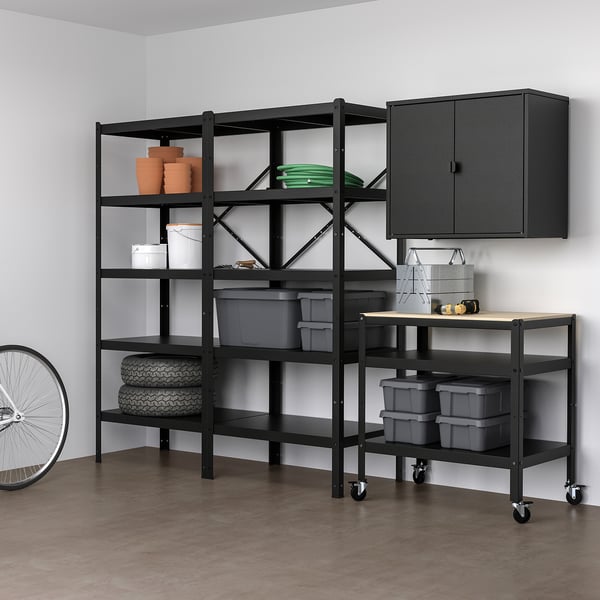 BROR storage system in black with metal shelves, tires, pots, bins, cabinet, and trolley for garage.