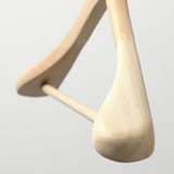 Wooden hanger close-up, light finish, smooth texture, curved hook, natural grain visible.