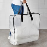 Person holding large white storage bag. The bag sturdy handles and a zipper, ideal for holding various items like tires, sports gear, and clothing.