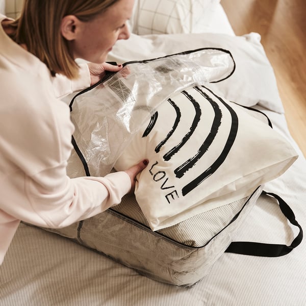 Woman holding love labeled, transparent storage bag.