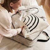 Woman holding love labeled, transparent storage bag.