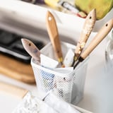 Mesh pencil holder, white. Holds wooden tools, sits on felt pads.