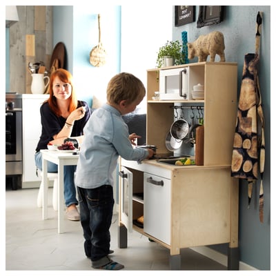 DUKTIG kids wooden kitchen, white and natural wood, with stove, sink, microwave, and storage.