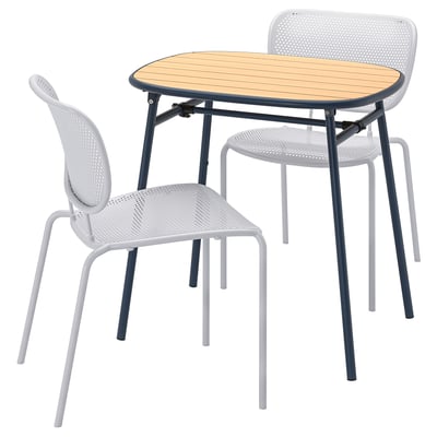 DUVSKÄR outdoor table & 2 chairs. Beige eucalyptus top, dark blue legs. White, stackable chairs with perforated seats and backs.