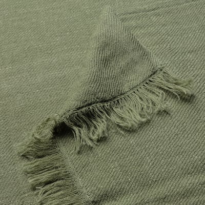 Green DYTÅG throw, fringe ends, soft linen-cotton blend.
