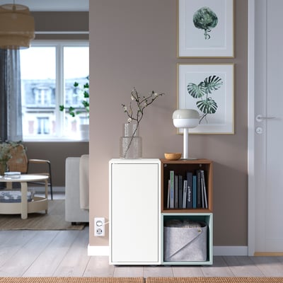 EKET storage unit: white, light blue, and wooden cube cabinet with open and closed sections, adjustable feet.