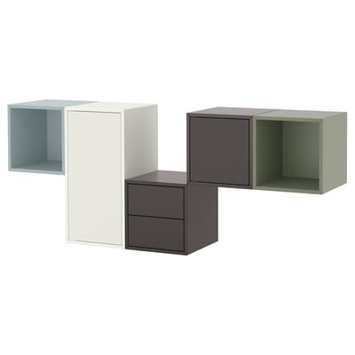 Four modern, cube-shaped storage units in light blue, white, dark grey, and green, arranged in a row.