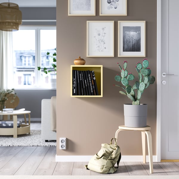 Living room with EKET cube, cactus, and art.