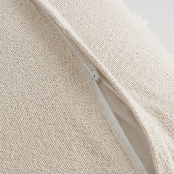 Close-up of cushion cover with zipper, soft cotton, white geometric pattern.