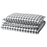 EKTANDVINGE bedding set featuring black & white checkered design, folded neatly. Made from organic cotton.