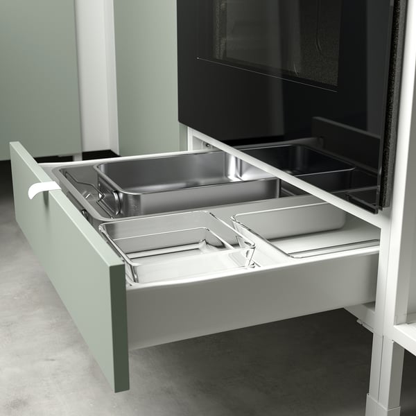 Drawer pulled out, showing dividers for organizing kitchen tools.