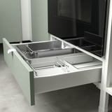 Drawer pulled out, showing dividers for organizing kitchen tools.