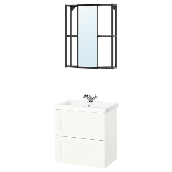 Modern bathroom setup featuring ENHET white vanity with two drawers, chrome faucet, a black-framed mirror, and a stylish container.