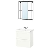 Modern bathroom setup featuring ENHET white vanity with two drawers, chrome faucet, a black-framed mirror, and a stylish container.