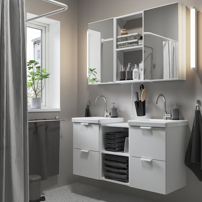 Modern bathroom with ENHET white twin vanity. Mirrors, counter space, and storage for towels and toiletries. Clean, symmetrical, and efficient layout.