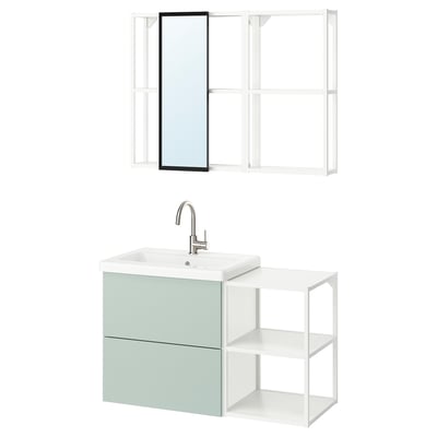Modern bathroom setup: ENHET light gray-green cabinet, metallic sink, and mirror.