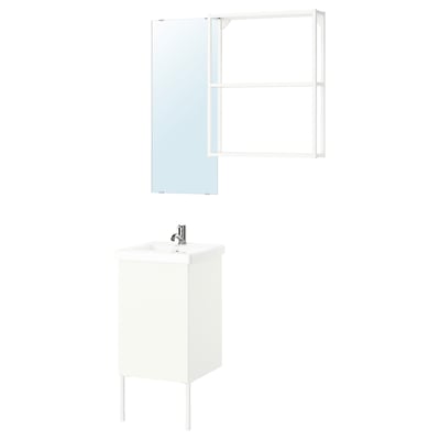 A minimalist white bathroom setup with a sink cabinet, mirror, and wall shelf.