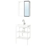 White bathroom setup: wall-mirror, metal frame; open shelf unit; single vanity with silver faucet.
