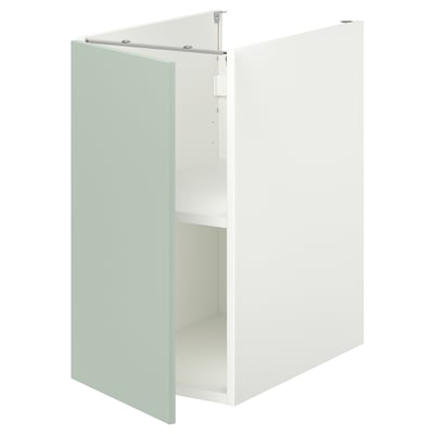 An ENHET base cabinet in pale grey-green with one open door revealing an empty shelf inside.