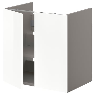 A white ENHET base cabinet for a washbasin with shelves. It glossy white doors, sleek design, and offers storage space for towels and toiletries.