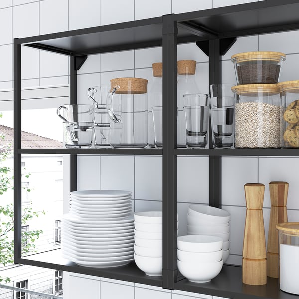 Modern kitchen shelving unit with glasses, plates, and jars. Offers both open and closed storage solutions, optimizing vertical space.