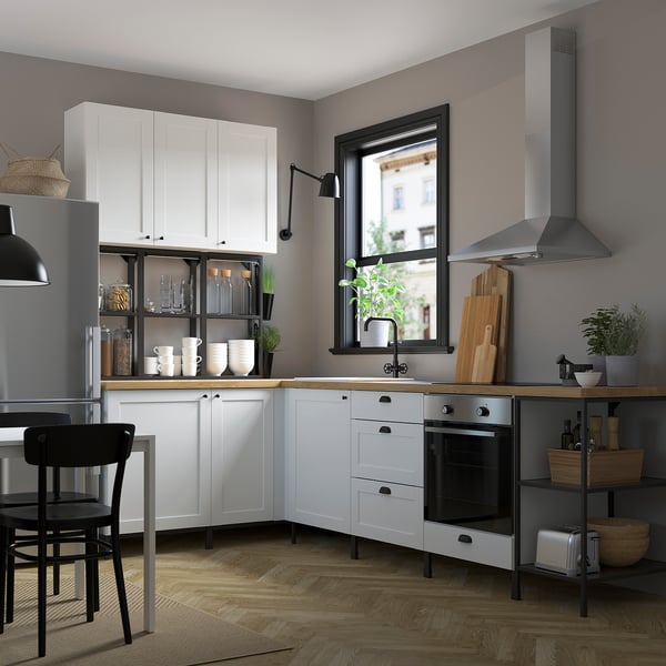 Modern kitchen with white ENHET cabinets, clean lines, and stainless steel appliances, generating a spacious, organized culinary space.