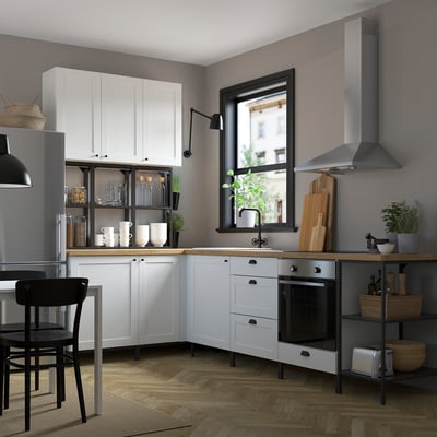 Modern kitchen with white ENHET cabinets, clean lines, and stainless steel appliances, generating a spacious, organized culinary space.