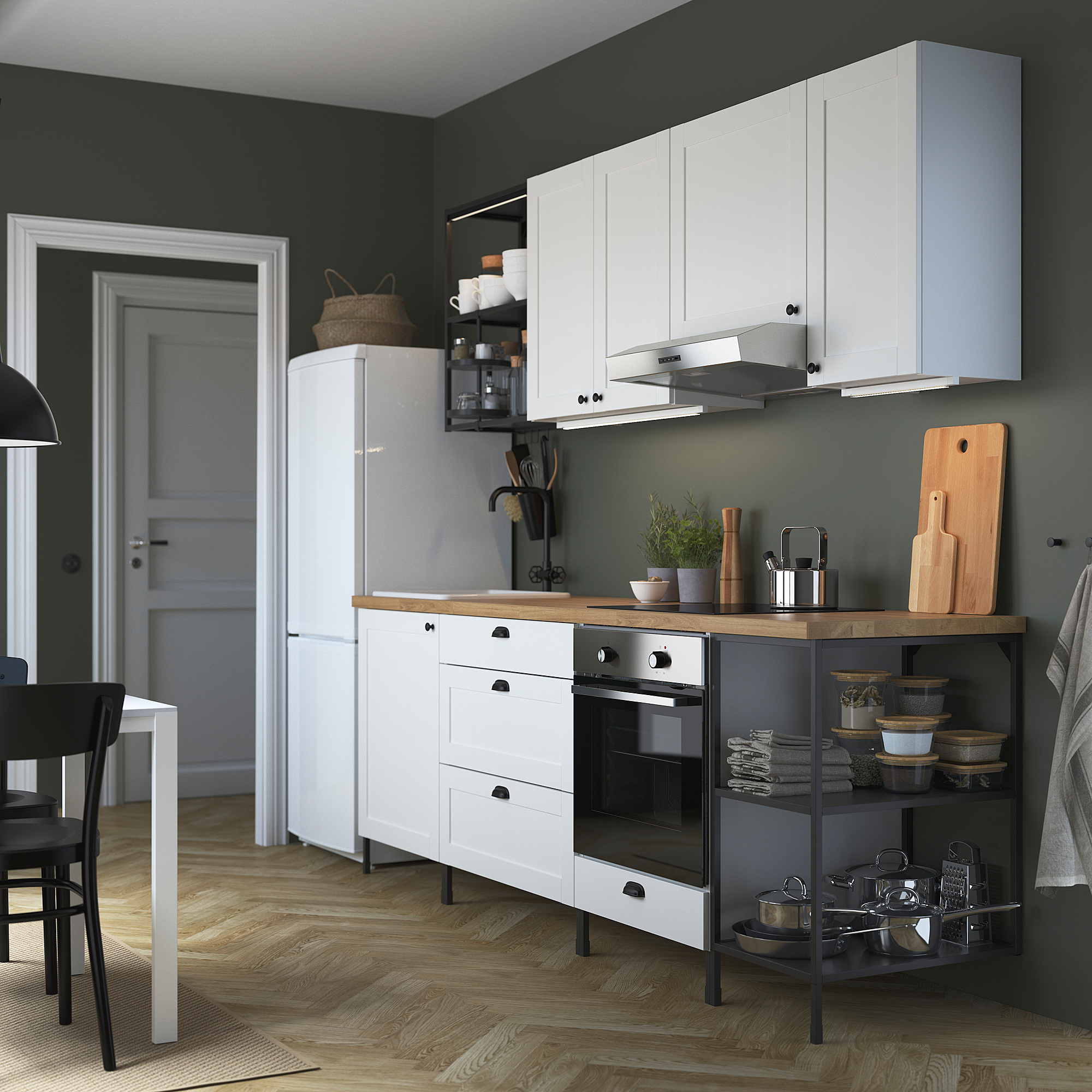 Modern kitchen with ENHET cabinets, oven, sink, and utensils. Clean, minimalist design.