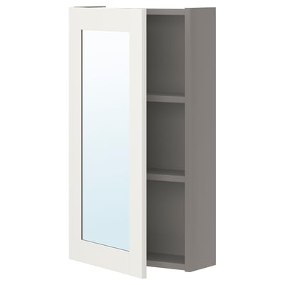 Gray ENHET cabinet with mirrored door, two shelves, boosts room light.