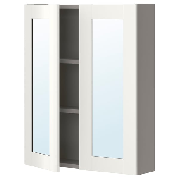 A white ikea ENHET wall cabinet with a mirror door and two shelves for bathroom storage.
