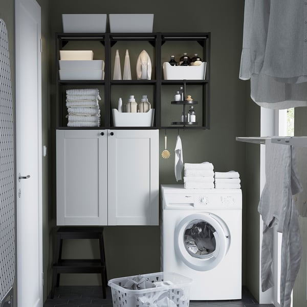 White ENHET storage with laundry items, washing machine, stool, and basket.