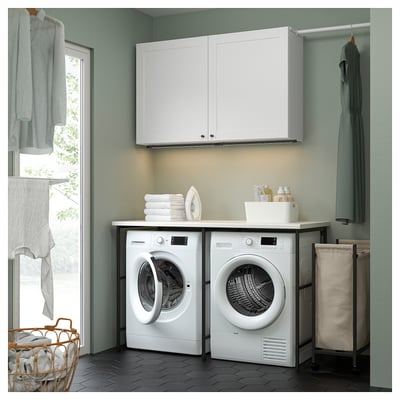 ENHET laundry: 2 machines, cabinets, hangers, baskets. Clean, organized space.