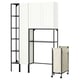 Modern ENHET storage system: white cabinet, black metal frames, shelves, and beige laundry bag on wheels.