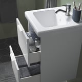 Modern bathroom sink cabinet with two drawers, clean design, towel storage.