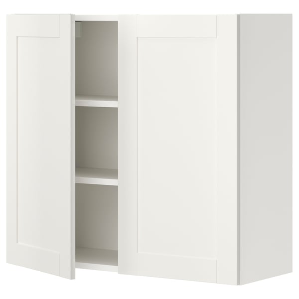 White ENHET wall cabinet with 2 shelves, framed doors, particle board & plastic foil, rectangular shape, simple design.