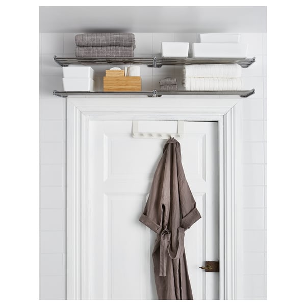 Over-door bathroom organizer with hooks in white, holding towels and robe.