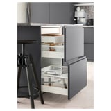 Modern kitchen drawer in gray with white and metallic compartments; push-to-open feature.
