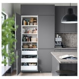 Modern gray kitchen with push-to-open drawers and shelves, featuring sleek handles, organized with various kitchen items, and a hanging black lamp.