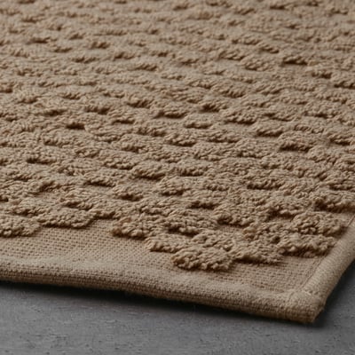 Beige FJÄLLKATTFOT bath mat, cotton, rectangular, textured.
