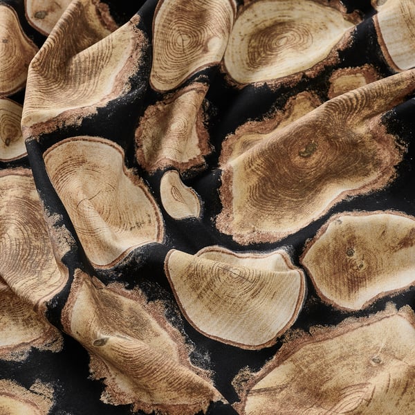 Close-up of high-quality cotton fabric showcasing an intricate wood log pattern, perfect for various sewing projects.