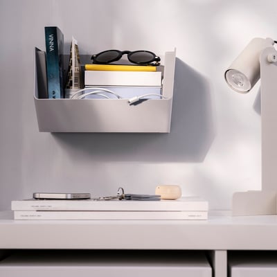 A white FODERTRÅG storage organizer, rectangular-shaped, made of recycled plastic for desk or wall mounting.