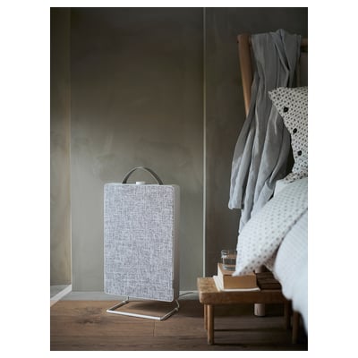 A grey ikea FÖRNUFTIG air purifier and its filter. Its sleek, rectangular, and stands on a metal base. A handle is on top for easy carrying.