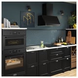 Modern kitchen with matte black appliances, hexagonal tiles, and wooden accents.